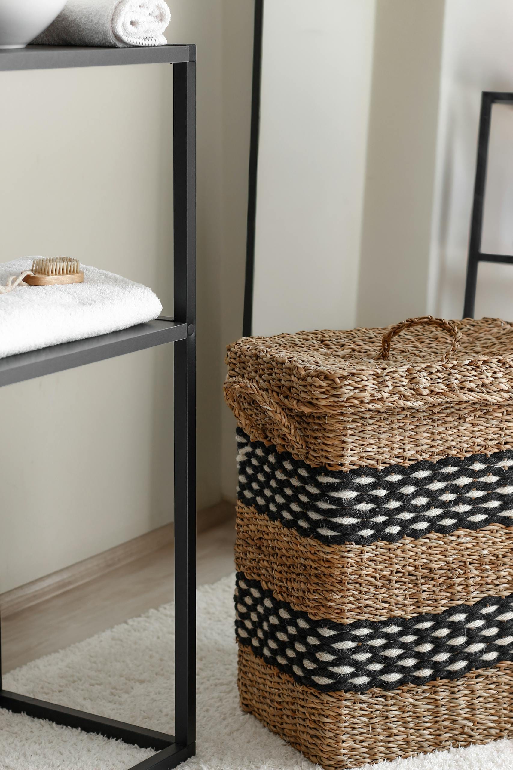 Elegant woven laundry basket in a modern bathroom interior, showcasing minimalist design and stylish details.