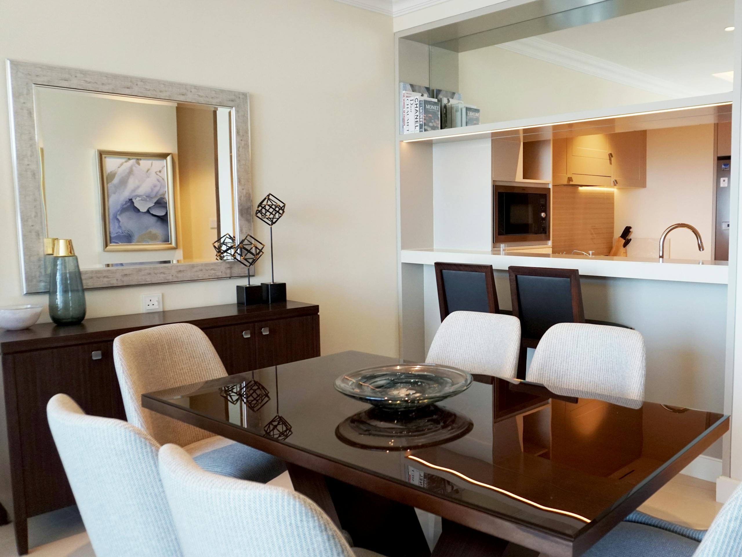 Elegant modern dining room showcasing sleek furniture and minimalist decor in a contemporary home setting.